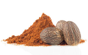 Spices dried seeds of fragrant nutmeg and grated nutmeg isolated on a white background