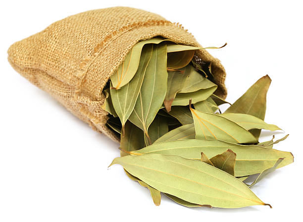 cassia leaves in sack over white background