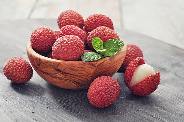 LYCHEE fresh lychee in bowl on a wooden background